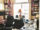 Home office featuring built-in bookshelves, large window, and functional desk at 1368 Royal Troon Dr, Castle Rock, CO 80104