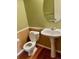 Neat powder room boasting hardwood floors, pedestal sink, and neutral paint at 1368 Royal Troon Dr, Castle Rock, CO 80104