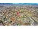 This aerial view shows a neighborhood near the mountains at 715 Zang St, Lakewood, CO 80401