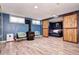Cozy basement room featuring a wood-burning stove and sliding barn doors to the bedroom at 715 Zang St, Lakewood, CO 80401
