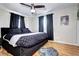 Stylish bedroom featuring a black bed frame, wood floors, and modern accents at 715 Zang St, Lakewood, CO 80401