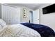 Cozy bedroom with a comfortable bed, closet space, and television at 715 Zang St, Lakewood, CO 80401