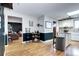 Bright kitchen open to the living room with white cabinets, granite countertops and stainless appliances at 715 Zang St, Lakewood, CO 80401