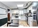 Bright kitchen with white cabinets, granite countertops and stainless appliances, and a skylight at 715 Zang St, Lakewood, CO 80401