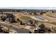 An aerial view shows the house in a neighborhood near a golf course with partial icy ponds at 7965 S Titus Ct, Aurora, CO 80016