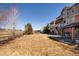 Spacious backyard with large lawn, covered patio area, with views of the nearby golf course at 7965 S Titus Ct, Aurora, CO 80016