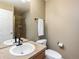 Bathroom with tile vanity, walk-in shower, toilet, and natural light from the window at 7965 S Titus Ct, Aurora, CO 80016