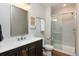 Stylish bathroom features modern vanity, framed mirror, and a glass-enclosed shower for a spa-like experience at 7965 S Titus Ct, Aurora, CO 80016