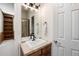 Bathroom featuring a vanity with a mirror and sink, with views into the bedroom with an ensuite shower at 7965 S Titus Ct, Aurora, CO 80016