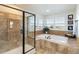 Beautiful bathroom with tiled shower, soaking tub, and bright windows providing lots of natural light at 7965 S Titus Ct, Aurora, CO 80016