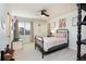 Cozy bedroom with natural light from the window, ceiling fan, and carpeted flooring at 7965 S Titus Ct, Aurora, CO 80016