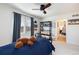 Well-lit bedroom with dark furniture, closet, and carpeted floors; a comfortable and inviting space at 7965 S Titus Ct, Aurora, CO 80016