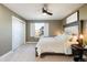 Comfortable primary bedroom with soft carpet, natural light from the window, and modern furniture at 7965 S Titus Ct, Aurora, CO 80016