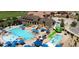 Stunning aerial view of the community pool featuring pools, a water slide, and lounge areas at 7965 S Titus Ct, Aurora, CO 80016