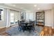 Bright dining area with wood floors, french doors to the outside, and an adjacent bookcase at 7965 S Titus Ct, Aurora, CO 80016