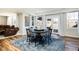 Bright dining area features a round table, gray rug, and natural light at 7965 S Titus Ct, Aurora, CO 80016