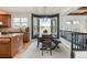 Bright dining area with large windows, a modern chandelier, and views of the surrounding landscape at 7965 S Titus Ct, Aurora, CO 80016