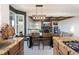 Open-concept dining room with a view into the cozy living room fireplace and built-in features at 7965 S Titus Ct, Aurora, CO 80016