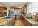 Spacious kitchen with stainless steel appliances, granite countertops, and ample cabinet space at 7965 S Titus Ct, Aurora, CO 80016