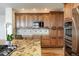 Traditional kitchen with granite countertops, tile backsplash, stainless steel appliances, and hardwood flooring at 7965 S Titus Ct, Aurora, CO 80016