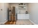 A stainless steel refrigerator and kitchenette space that offers a sink, cabinets, and granite countertops at 7965 S Titus Ct, Aurora, CO 80016