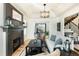 Cozy living room with fireplace, dark mantle, and views of the outdoor landscaping through shuttered windows at 7965 S Titus Ct, Aurora, CO 80016