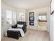 Cozy sitting area off the primary bedroom with shuttered windows, leather chair, and view of the ensuite bathroom at 7965 S Titus Ct, Aurora, CO 80016