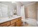 Clean bathroom with tub, shower, and light wood vanity at 2139 Clay St, Denver, CO 80211