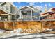 Two-story gray house with a white porch and a wooden fence in front at 2139 Clay St, Denver, CO 80211