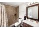 Bathroom with a tiled shower, modern vanity, and a framed mirror at 4010 E 129Th Way, Thornton, CO 80241