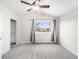 Bright bedroom with plush carpet, ceiling fan, and a large window with neighborhood views at 4010 E 129Th Way, Thornton, CO 80241