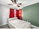 Cozy bedroom with a ceiling fan, plush carpet, and bright red curtains at 4010 E 129Th Way, Thornton, CO 80241