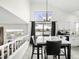 Bright dining room with a chandelier, large window, and stylish dining table with black leather chairs at 4010 E 129Th Way, Thornton, CO 80241