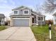 Two-story home with stone accents, gray siding, and a two-car garage in a well-maintained neighborhood at 4010 E 129Th Way, Thornton, CO 80241