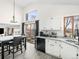 Open-concept kitchen and dining area, with granite counters, stainless appliances, and sleek cabinets at 4010 E 129Th Way, Thornton, CO 80241