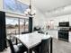 Bright kitchen and dining area with a modern chandelier, stainless steel appliances, and white cabinetry at 4010 E 129Th Way, Thornton, CO 80241