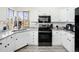 Bright, remodeled kitchen featuring white cabinets, modern appliances, and a window above the sink at 4010 E 129Th Way, Thornton, CO 80241