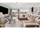 Inviting living room with a plush sectional sofa, entertainment center, sliding glass door to the backyard at 4010 E 129Th Way, Thornton, CO 80241