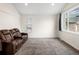 A cozy living room with carpet, a window view, and comfortable, powered reclining leather furniture at 4010 E 129Th Way, Thornton, CO 80241