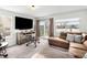 Welcoming living room featuring a sectional, a flat-screen TV, and sliding glass doors to the outdoor area at 4010 E 129Th Way, Thornton, CO 80241