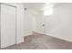 Finished basement area featuring fresh paint, carpeting, and ample natural light from the window at 1617 S Quitman St, Denver, CO 80219
