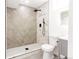 Modern bathroom with a large walk-in shower featuring herringbone tile design at 1617 S Quitman St, Denver, CO 80219