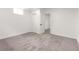 Bright bedroom with gray carpet, white walls, closet, and a neutral door at 1617 S Quitman St, Denver, CO 80219