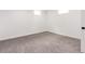 This is a clean, carpeted bedroom with natural light from a small window and white walls at 1617 S Quitman St, Denver, CO 80219