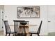 Modern dining room with a round wood table and stylish black chairs at 1617 S Quitman St, Denver, CO 80219