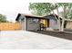 Stylish home featuring gray brick, dark trim, and a spacious concrete driveway at 1617 S Quitman St, Denver, CO 80219