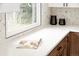 Modern kitchen with white countertops, white cabinets and a tiled backsplash at 1617 S Quitman St, Denver, CO 80219