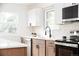 Modern kitchen with stainless steel appliances and tiled backsplash at 1617 S Quitman St, Denver, CO 80219