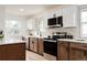 Modern kitchen with stainless steel appliances and tiled backsplash at 1617 S Quitman St, Denver, CO 80219