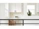 Modern kitchen with white countertops, white cabinets and a tiled backsplash at 1617 S Quitman St, Denver, CO 80219